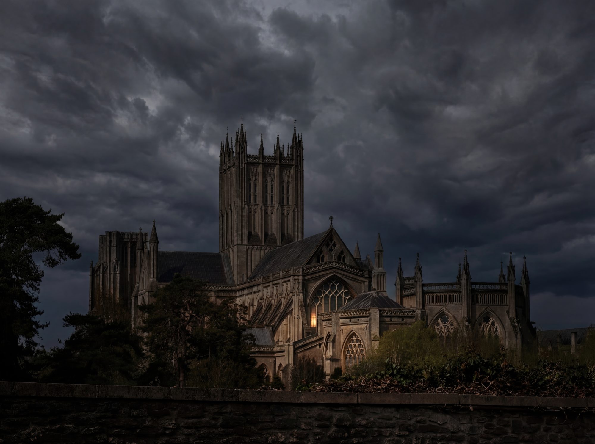 A Gothic cathedral rises beneath heavy storm clouds, its stone mass illuminated by a single warm interior light, creating a quiet tension between shelter and en...